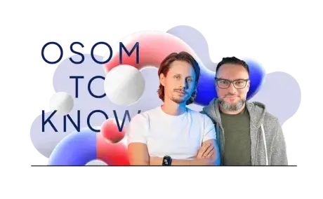 Two men standing side by side against a colorful abstract background of red, white, and blue spheres with the text "OSOM TO KNOW" partially visible. One is in a white shirt with arms crossed, the other in glasses and a gray hoodie.