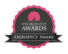 A circular badge with a pink scalloped edge and dark center, displaying "Web Excellence Awards"—perfect for a leading WordPress development agency—with "EXCELLENCE AWARD" on a black ribbon across the bottom.